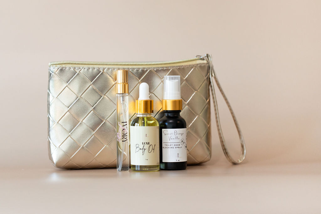 travel perfume and travel body oil. gold quilted  with skincare products on a beige background
